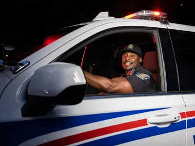 LPS Officer in cruiser, night image