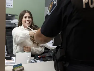 Female civilian employee handing papers to male officer