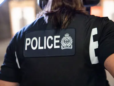 Female LPS officer back view, vest with POLICE written across the back & LPS Logo