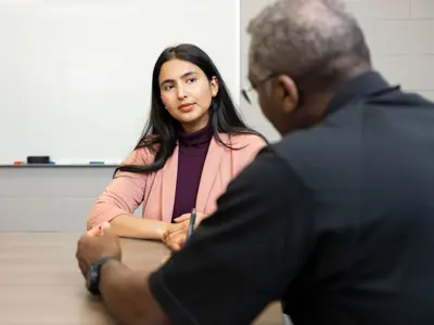 Officer and Civilian Applicant sitting at desk