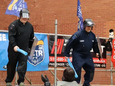 2 officers in uniform jumping in pool in winter